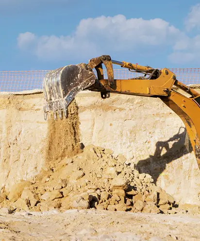 Yellow excavator digging
